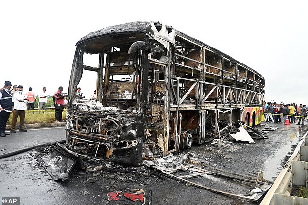 The charred remains of a passenger bus lie on a highway in Chinnatekuru village, where it caught fire early Friday after a collision with a motorbike in India on October 24 2025
