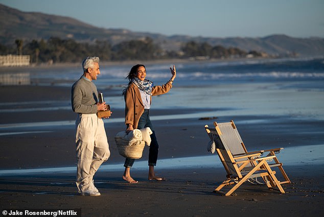 Meghan during a still from the second installment of her Netflix series With Love, Meghan, as she is spotted walking barefeet on the beach with guest and Queer Eye star Tan France