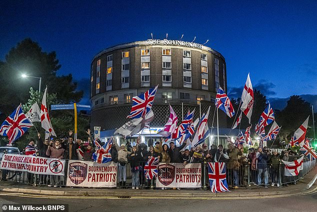 Around 100 protesters gather outside The Roundhouse hotel, that houses asylum seekers in Bournemouth on Friday