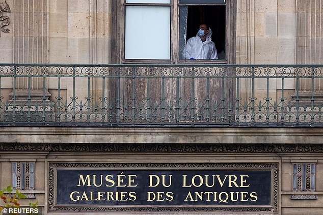 Forensic teams inspects a window believed to have been used in the Louvre museum heist