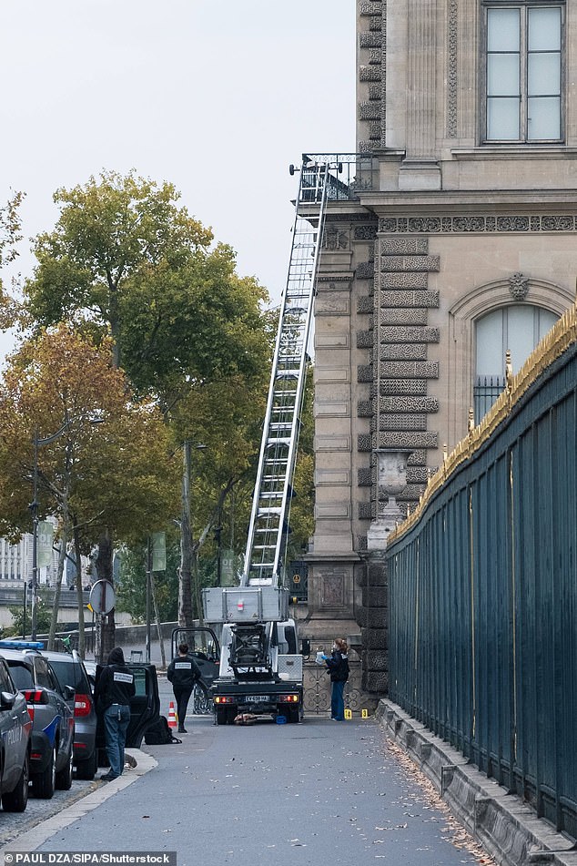 Police and Crime scene officers secure a furniture elevator extended to the balcony of a gallery at the Louvre Museum