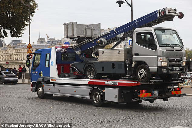 The police transport a furniture elevator used by robbers to enter the Louvre Museum