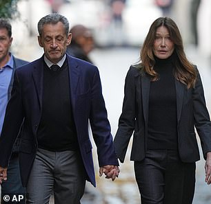 Former French president Nicolas Sarkozy with wife Carli Bruni as he was jailed for using illicit funds in an election