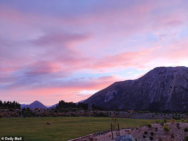 At sunrise, pink clouds float in a lavender-coloured sky, glowing brighter as the sun gets higher