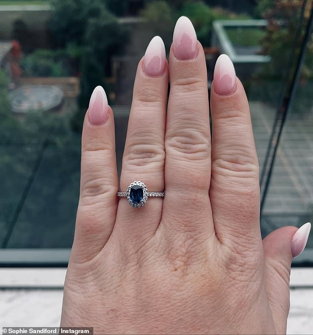 She also proudly showed off her sapphire engagement ring which sat on a silver band surrounded by dazzling diamonds