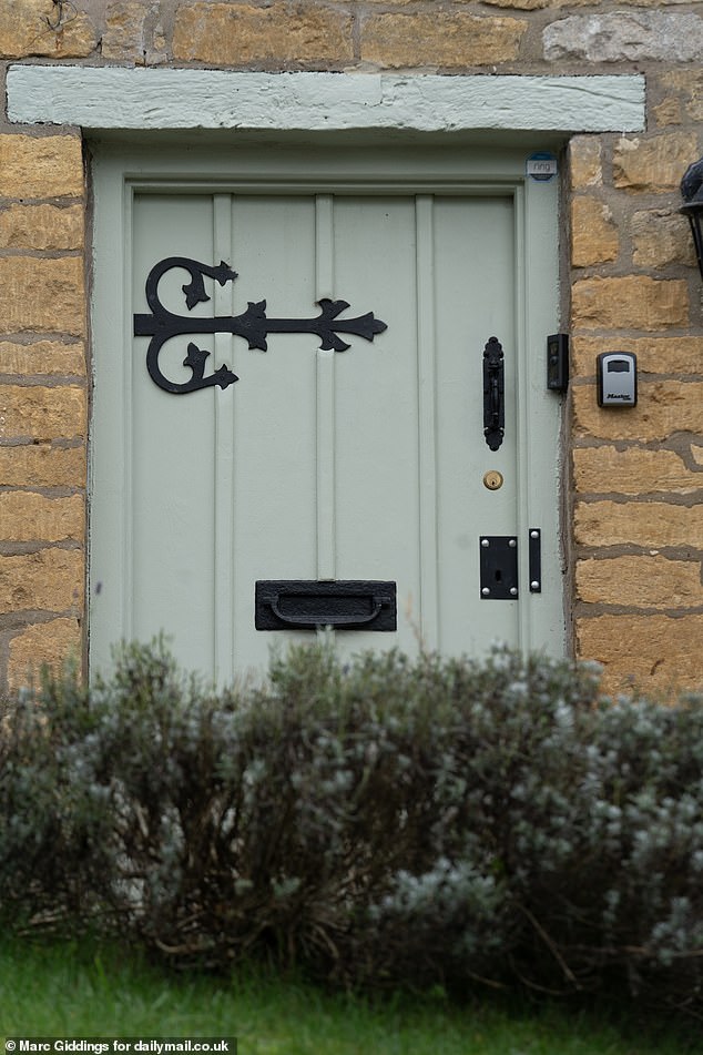 A traditional 'Cotswolds Green' painted front door. 'Busy bodies' in the village feel doors should only be painted in the traditional colour or white