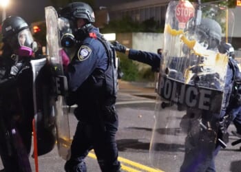A rioter clashes with federal officers at an Immigration and Customs Enforcement detention facility in Portland, Oregon, on Aug. 20, 2020.