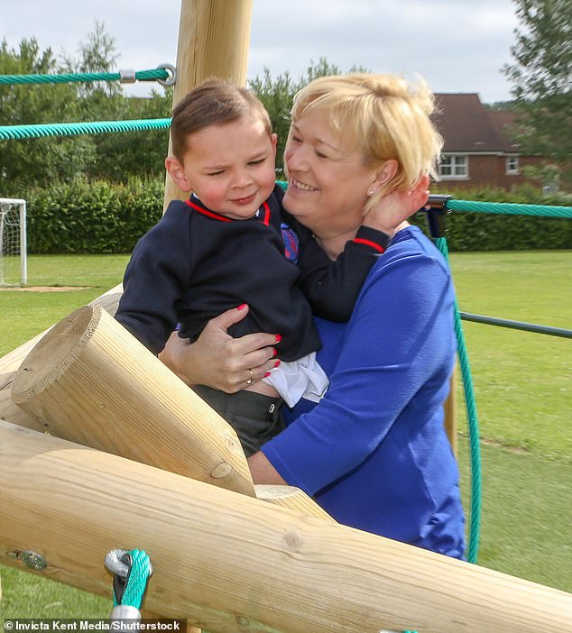 Paula hugging her adopted son, Tony, now ten, in a park on August 11, 2018