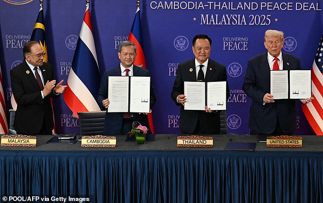 From left to right, Ibrahim applauded as Cambodia's Prime Minister Hun Manet, Thailand's Prime Minister Anutin Charnvirakul and Trump held up documents during the ceremonial signing of a ceasefire agreement between Thailand and Cambodia