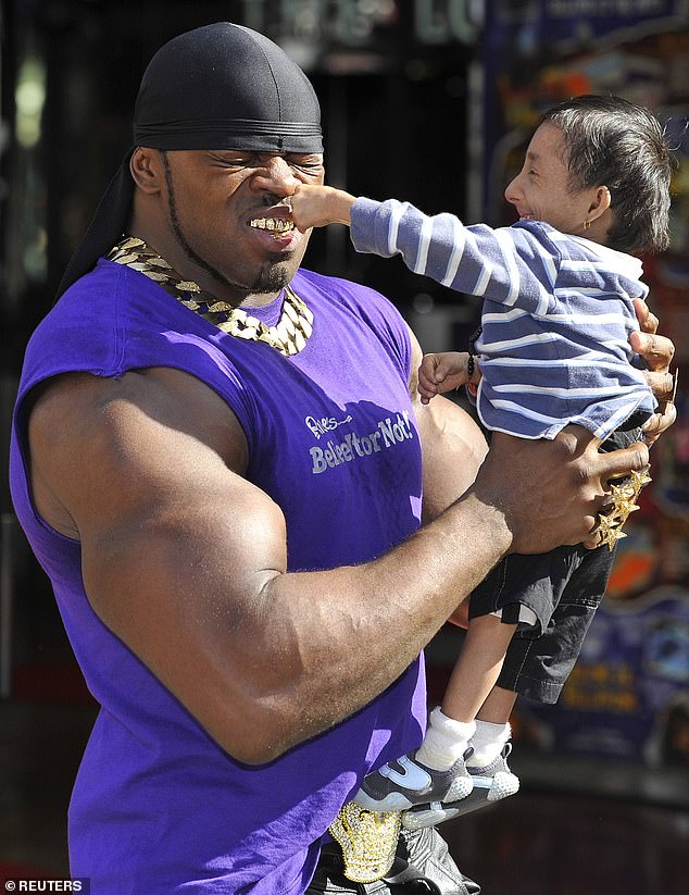 Khagendra Thapa Magar from Nepal (R) poses for photographers with Londoner Tiny Iron in central London September 9, 2010