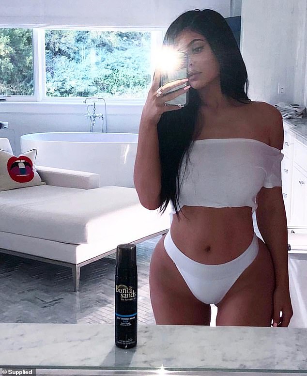 It went on to become one of the world's top-selling self-tanning brands that was sold for $450M (AUD) in 2023 (pictured Kylie Jenner with the brand)