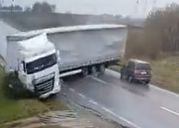 Horrifying moment skidding jackknifed lorry flattens car killing two after losing control on rain-soaked road