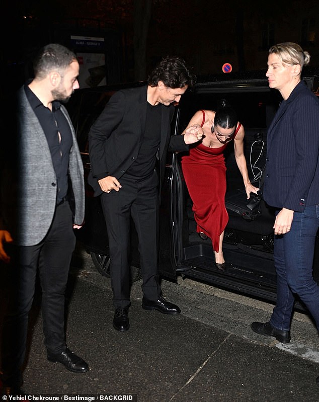 Justin helped Katy out of their car as they arrived for her birthday bash