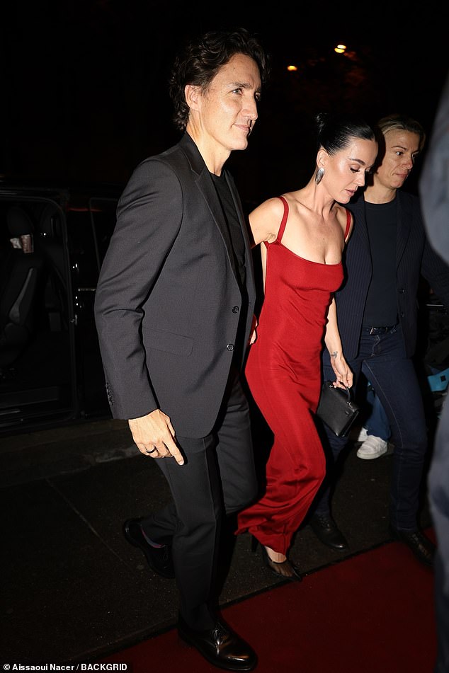 Katy dressed to impress for the evening in an eye catching figure hugging red gown which boasted a scoop neckline and thigh high split