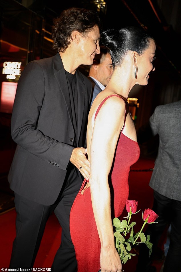 He put a caring hand on her back as they headed for their waiting car