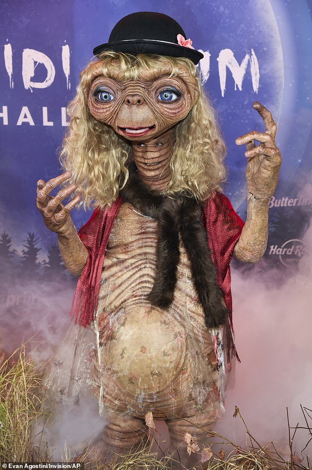 'It was so heavy, holding that head on my head,' she recalled. 'It was literally - because it goes to the back, it goes to the front'; Klum seen dressed as E.T. in 2024