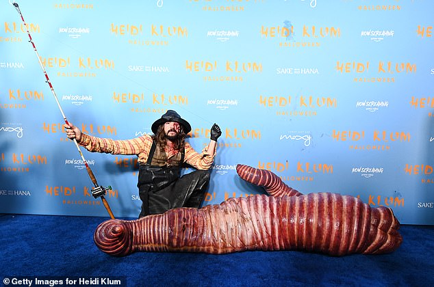 Klum recently told People that this year's look will be 'ugly' and that she enjoys doing something 'different' every year; seen above as a worm with husband Kaulitz (fisherman)