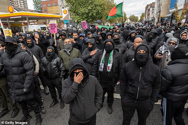 Members of the Bangladeshi community dressed in all black took to the streets to oppose a far-right march which was banned from entering Whitechapel on Saturday
