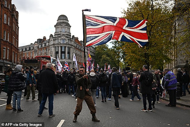 A man waves a large Union Jack flag at a march in support of UKIP on Saturday