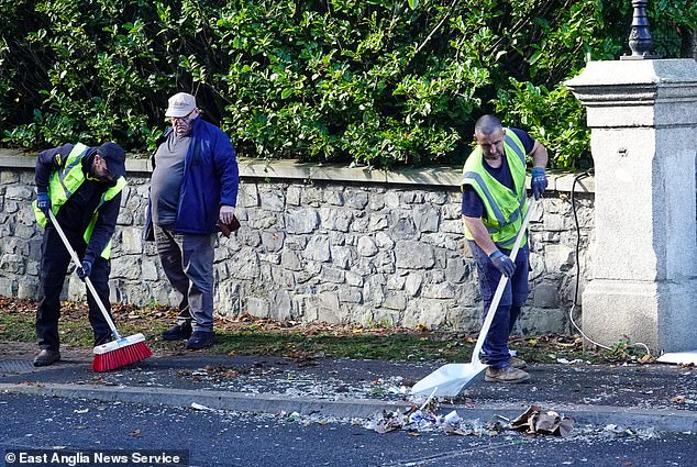 Paper bags and other rubbish is seen being cleared by council workers