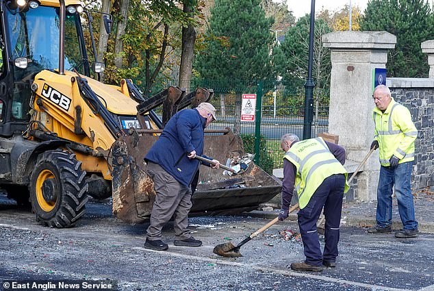 Council workers clear out the damage left behind following the protests