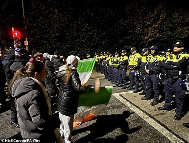 Gardai officers block protesters near the Citywest Hotel in Saggart