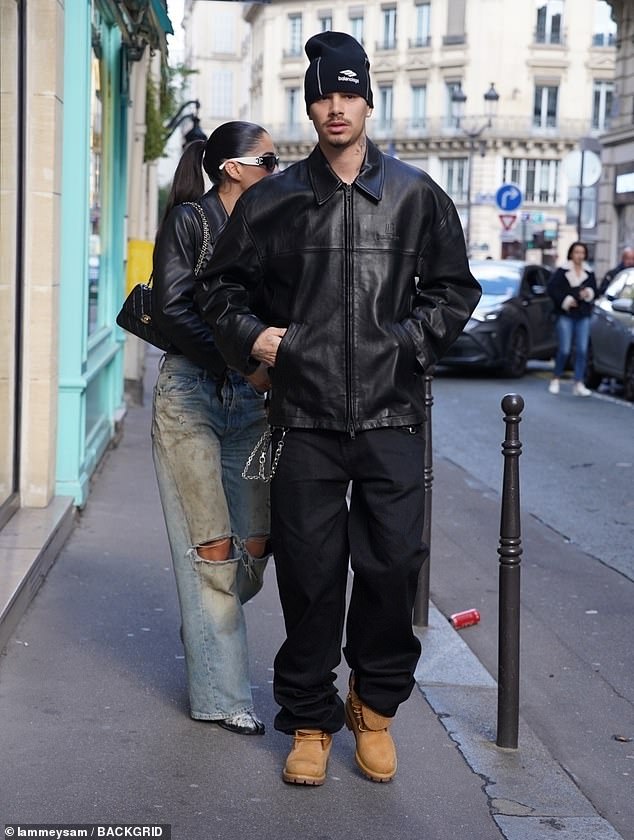 The son of David and Victoria Beckham looked cool in the oversized jacket which he teamed with black jeans, tan Timberland boots and a black winter hat