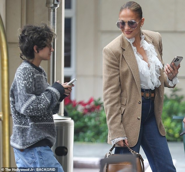 While strolling towards the entrance, Lopez was seen turning to glance over her shoulder and sent a smile in Emme's direction