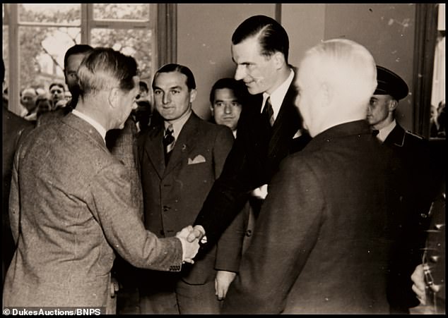 Edward shakes hands with Nazi officials during a tour of a German car factory. Edward did attempt to be muted in his praise of the regime, choosing only to applaud its welfare policies