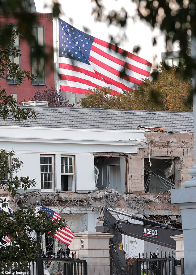 Trump's large American flag can be seen in the background as workers tear down the White House's East Wing on Monday to make room for the $250 million White House ballroom project