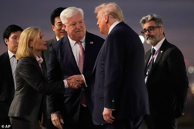 President Donald Trump was greeted at Tokyo's Haneda Airport Monday evening by U.S. Ambassador George Glass (second from left) and other U.S. officials