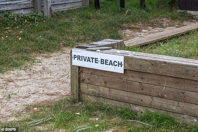 A sign reads 'private beach' - despite residents saying they have enjoyed access to the beach for over 80 years