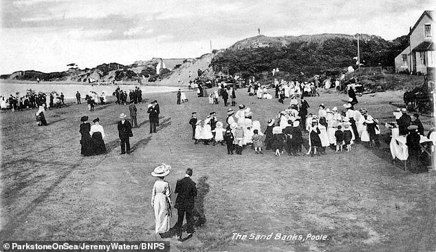 Victorian families enjoying the beach in Sandbanks. Residents argue they have historically been able to walk all the way down
