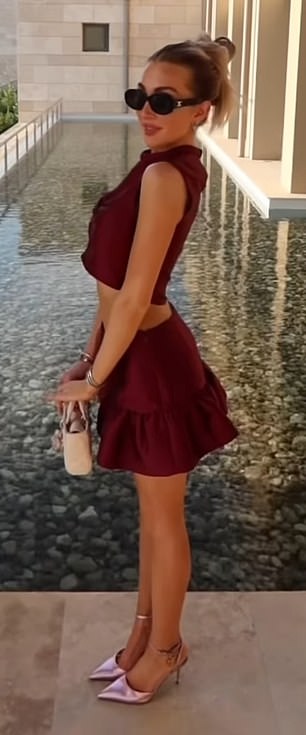 The singer's voice can be heard, instructing her what to do next as she angled her body for the camera in the throwback video