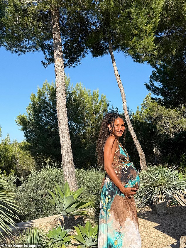 She also shared a snap wearing a stylish maxi dress cradling her baby bump