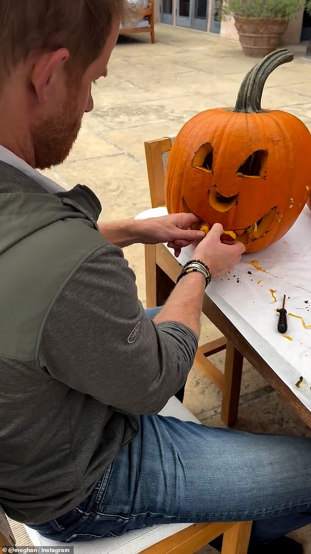 The children watched on in awe at their father, Prince Harry, carved a pumpkin just in time for the spooky season
