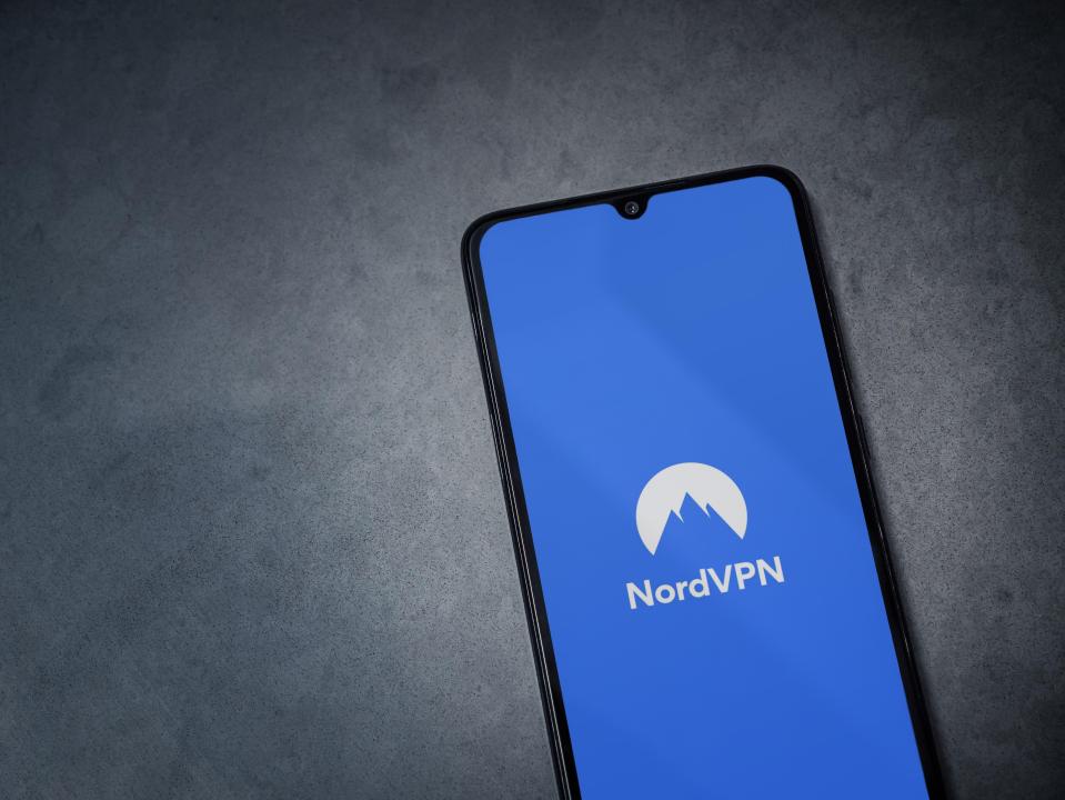 NordVPN app launch screen with logo on a black smartphone.