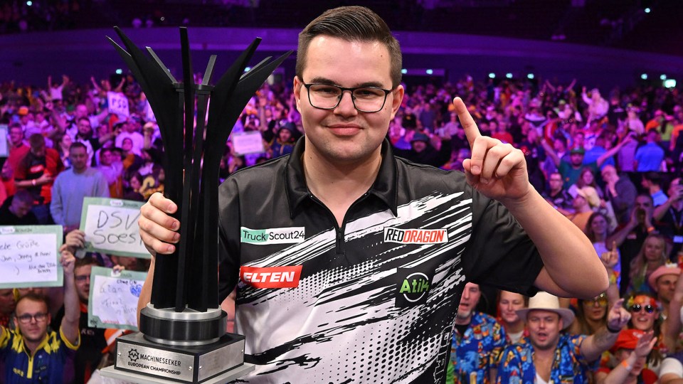 Darts player Ricardo Pietreczko holding the Machineseeker European Championship trophy.