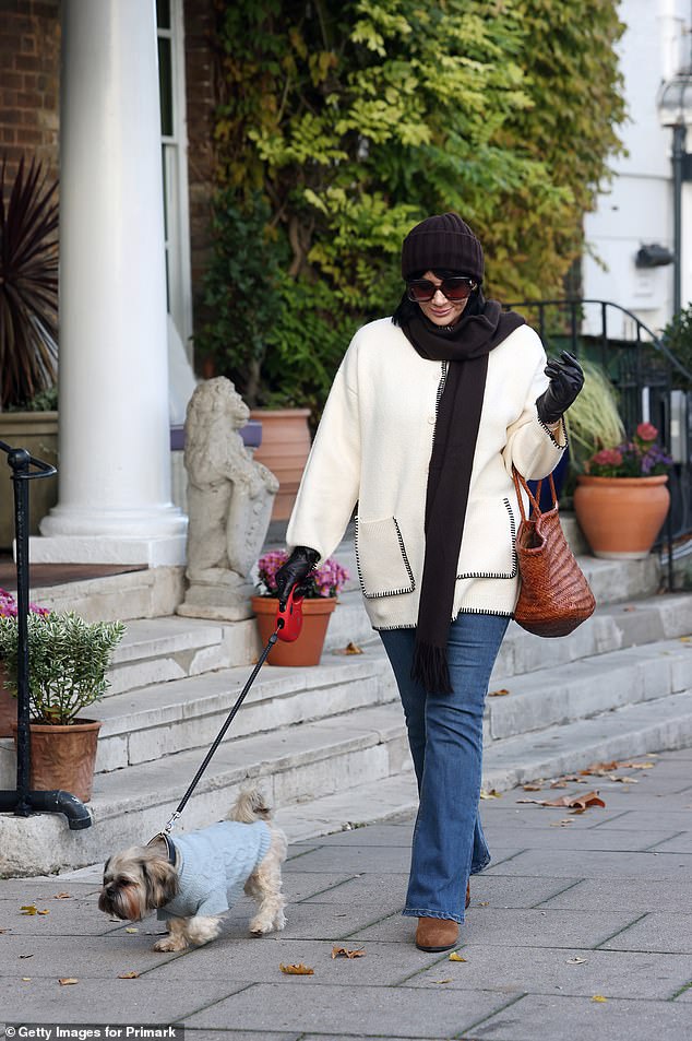 Adding inches to her frame, Martine slipped into a pair of brown heeled boots and toted around her belongings in a brown bag