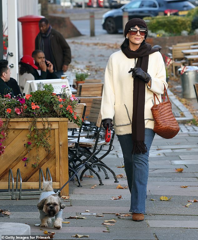 The former EastEnders star looked effortlessly chic in a white Primark cardigan which featured a stylish black knit trim while out with her pet dog in East Molesey