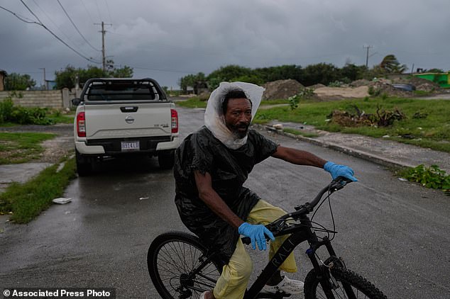 A man rides a bicycle ahead of the forecast arrival of Hurricane Melissa in Kingston on Sunday