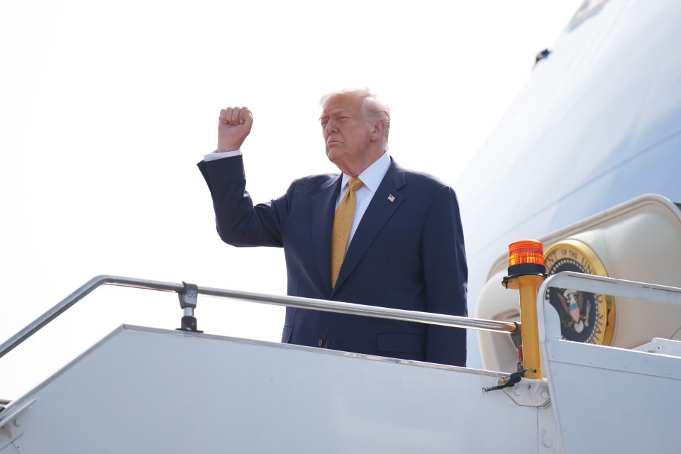 President Trump clenching his fist while boarding Air Force One.
