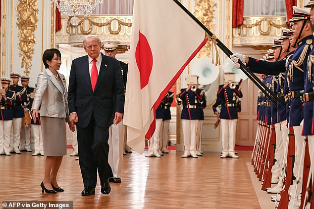 Japanese Prime Minister Sanae (left) walks alongside President Donald Trump (right) at a welcome ceremony at the Akasaka Palace in Tokyo Tuesday morning