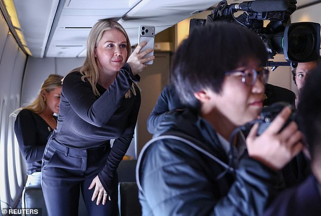 White House press secretary Karoline Leavitt captures President Donald Trump participating in a gaggle with reporters on board Air Force One en route to Tokyo, Japan on Monday