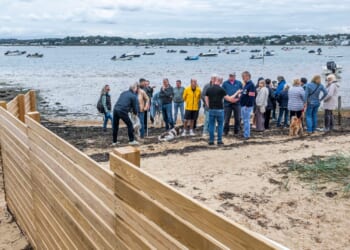 Millionaire neighbours locked in bitter row over 'oppressive' 40ft privacy fence suddenly built on popular UK beach