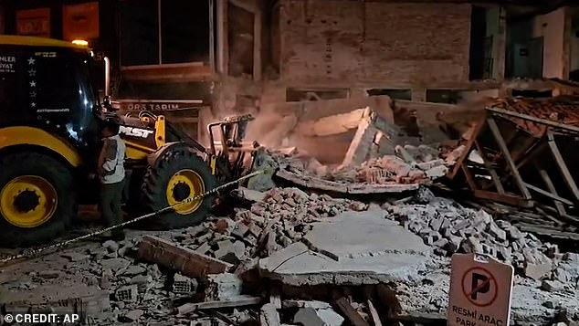 Bulldozers working through the rubble in Sindirgi. Ismail Ustaoglu said mosques, schools and sports halls remained open as evacuation shelters for people reluctant to return home