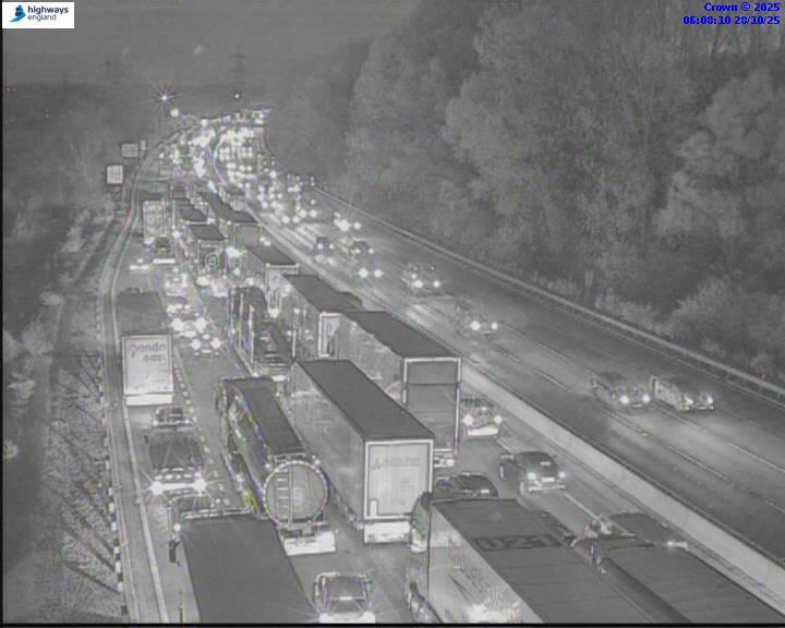 Infrared image of heavy traffic on a multi-lane highway at night.