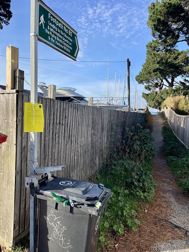 A council sign on the roadside reads that the path, formally known as ¿Footpath 82¿ leads ¿to the shoreline¿ but not along the beach