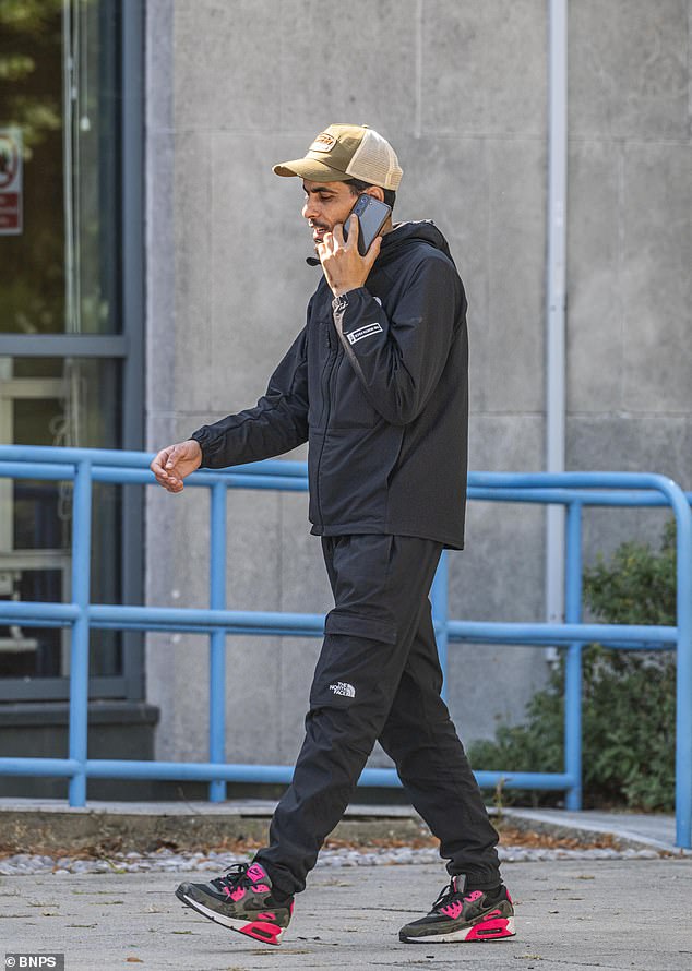 Zouari (pictured on his phone outside court wearing a North Face tracksuit and Nike Air Max trainers) came to the UK illegally in 2022 from Libya, where he said he faced a lot of political trouble, particularly because his family were pro-Gaddafi