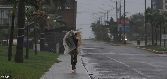 A man walks in Kingston, Jamaica, as Hurricane Melissa approaches, Tuesday, Oct. 28, 2025. (AP Photo/Matias Delacroix)